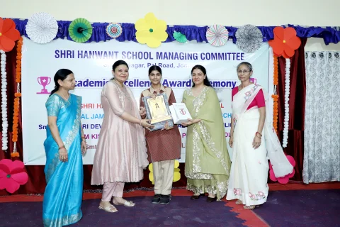 Student receiving an award at the academic excellence ceremony
