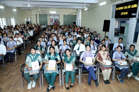 Student receiving award from chief guests at the HSMC board prize distribution ceremony